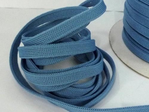 Flat woven polyester tape coiled on the floor