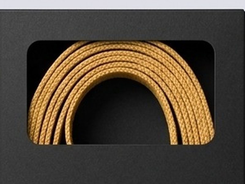 Coiled tape packed inside a die-cut window in a black box
