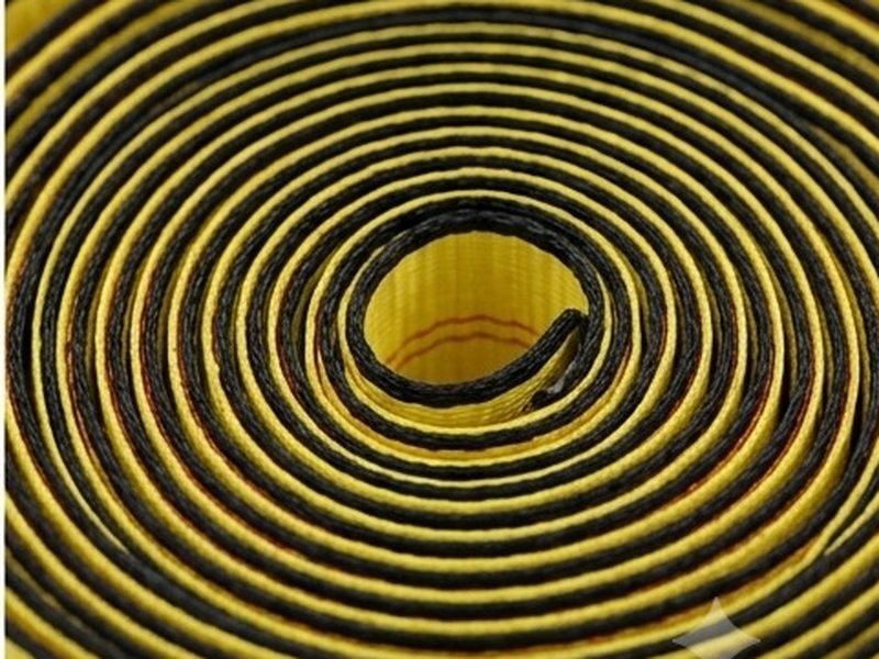 Top view of a coil of webbing with every wrap sitting flat